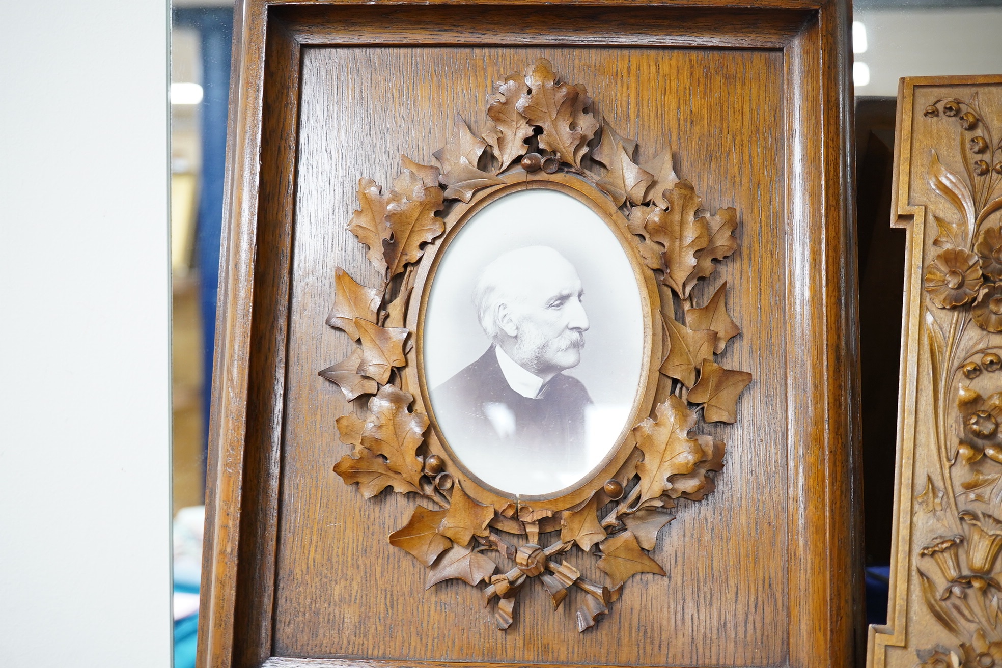 An oak photograph frame carved by Alfred Jones, another similar frame - related (his wife), 33cm high x 23cm wide, and a wall bracket carved by Alfred Jones and cased medal awarded to him, A Jones by The Carpenters Compa